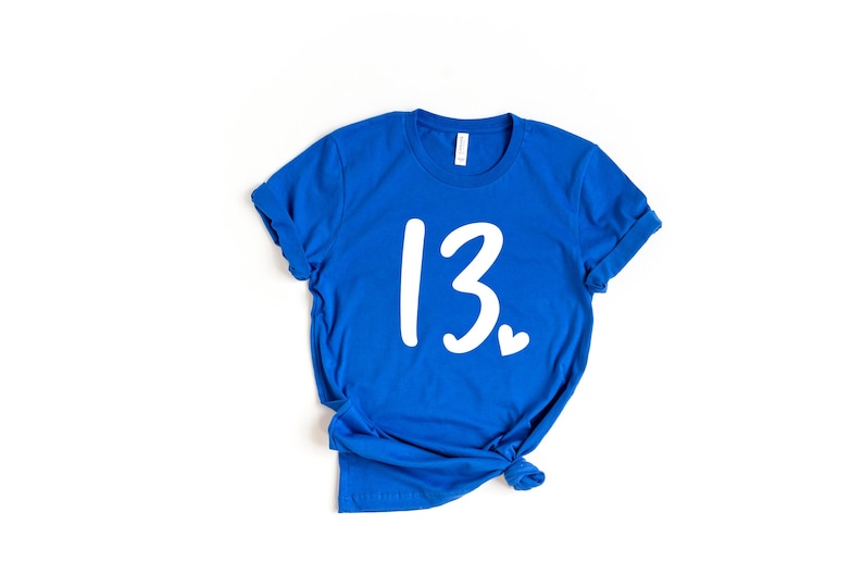 May include: A royal blue t-shirt with the number 13 and a small heart printed in white.