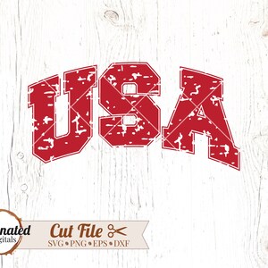 May include: Red distressed graphic of the word "USA" in a vintage style font. The graphic is on a white wood background.