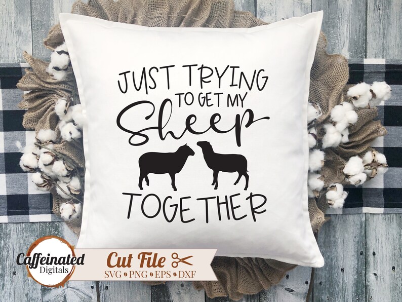 May include: White pillow with black text that reads "Just trying to get my sheep together". Two black sheep silhouettes are shown on either side of the text.