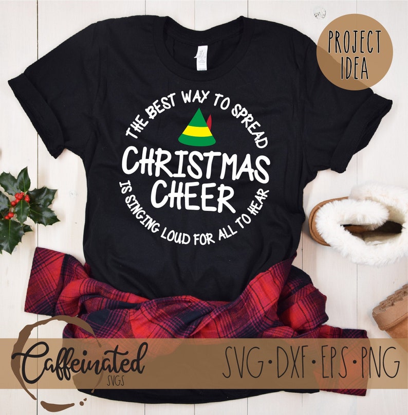 May include: Black t-shirt with a white circle design featuring a green elf hat and the text "The best way to spread Christmas cheer is singing loud for all to hear."