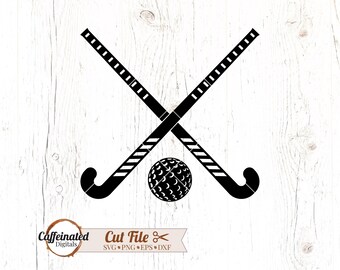 May include: Black graphic of two crossed field hockey sticks and a ball. The sticks have white stripes and a grid pattern. The ball has a textured surface. The image is on a white wood grain background.