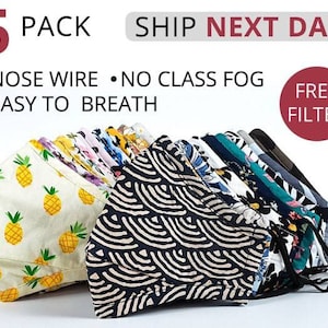 May include: A 5 pack of reusable face masks with different patterns. The masks are made of fabric and have a nose wire. The text "SHIP NEXT DAY" and "FREE FILTER" is visible in the image.