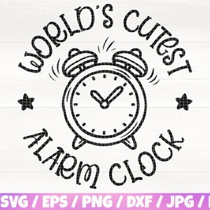 May include: Black and white illustration of a cartoon alarm clock with the text "World's Cutest Alarm Clock" around it. There are two stars on either side of the clock.