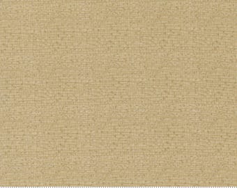 May include: A close-up of a beige fabric with a subtle textured pattern. The fabric has a slightly rough, linen-like feel. The fabric is perfect for quilting, sewing, and crafting projects.