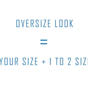 May include: White background with blue text that reads "OVERSIZE LOOK = YOUR SIZE + 1 TO 2 SIZE". The text is in a sans-serif font. The word "OVERSIZE" is at the top, followed by an equals sign, and then the rest of the text.