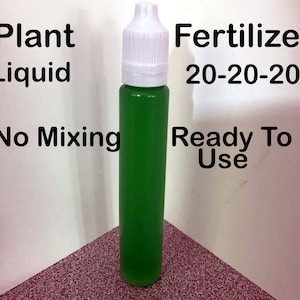 May include: A small green bottle of liquid plant fertilizer labeled "Plant Liquid Fertilizer 20-20-20 Ready To Use No Mixing".