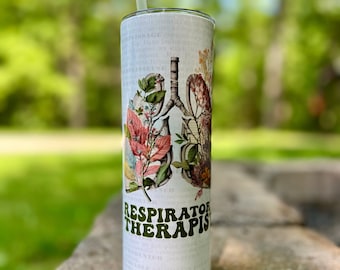 May include: White stainless steel tumbler with a floral design and the text "RESPIRATORY THERAPIST" in green letters. The tumbler has a straw.