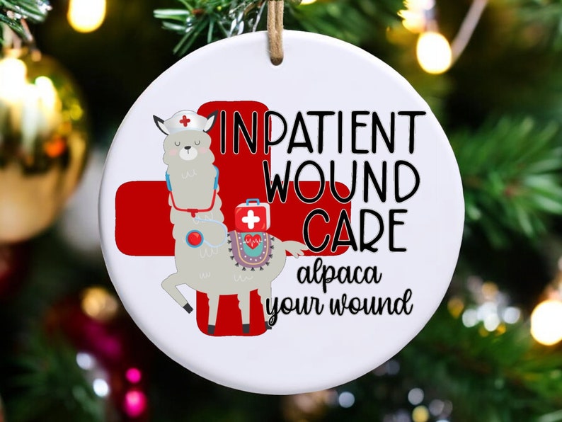 May include: A white ceramic ornament with a red cross and a cartoon alpaca wearing a nurse's hat and stethoscope. The text reads "Inpatient Wound Care alpaca your wound".