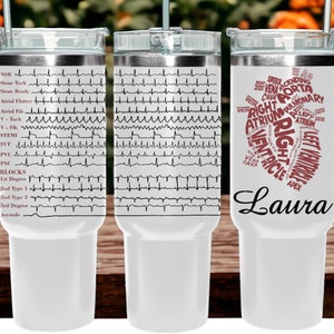 May include: A white stainless steel tumbler with a black and white EKG pattern on one side and a red heart with the words "RIGHT VENTRICLE" and "LEFT VENTRICLE" on the other side. The tumbler has a black lid and a white handle. The name "Laura" is printed on the bottom of the tumbler.