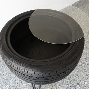 Bar-height tire table crafted from a real recycled tire, featuring a flush plexiglass top, solid wood base, and sturdy 24-inch metal legs, standing at 34 inches tall. This unique automotive table adds an industrial, modern touch to garages, man caves, bars, or home decor. Perfect as a high-top table, side table, or statement piece, it blends durability and style, making it a must-have for car lovers and those who appreciate repurposed furniture.