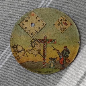 Chromolitografowana tarcza zegarka z I wojny światowej/Tarcza francuskiego zegarka z lat 1914-1915/Komiksowe rysunki z I wojny światowej/Kolekcjonerska część zegarka/Kolaż, rękodzieło lub naprawa zegarków