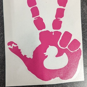 May include: Pink handprint decal with a white rubber ducky inside, forming a peace sign.