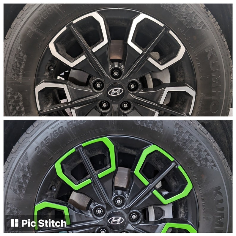 May include: A close-up of a black car wheel with a silver rim. The wheel has a green accent around the spokes. The tire is a Kumho Solus TA31 245/60 R18.