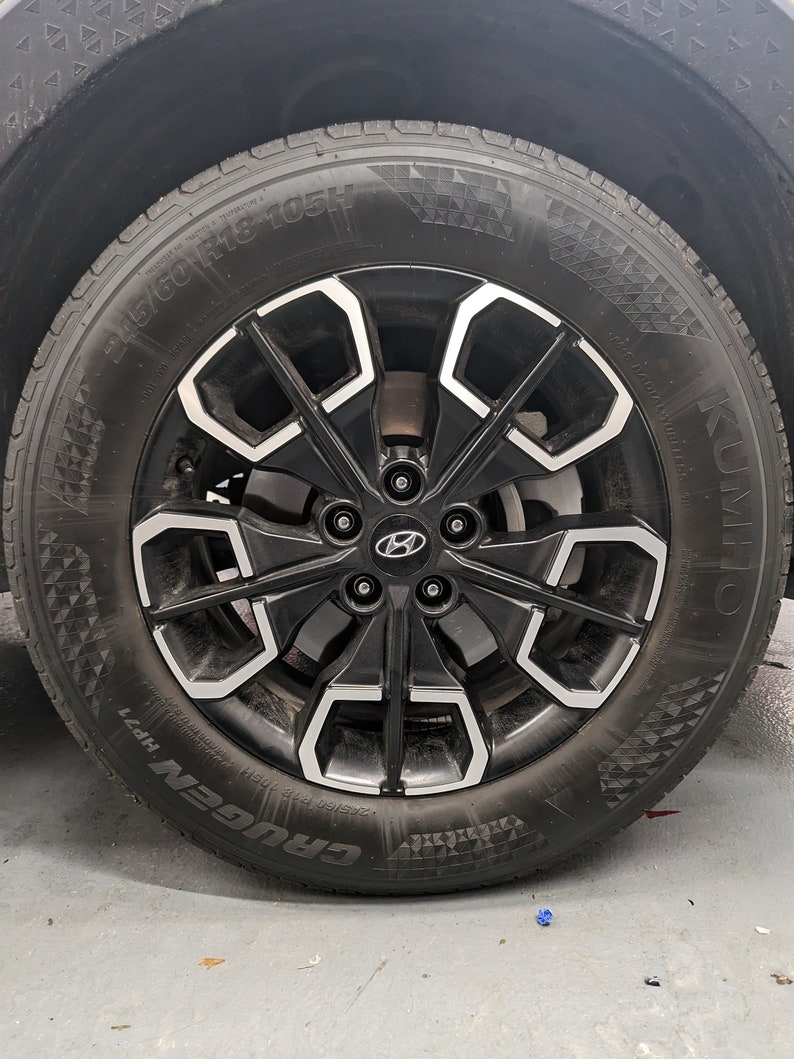 May include: A black tire with a silver rim and the text "KUMHO CRUGEN HP71 245/60 R18 105H" on the side.