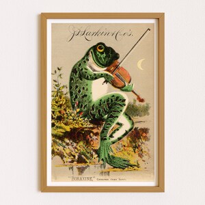 Puede incluir: Anuncio vintage enmarcado que muestra una rana verde tocando el viol&iacute;n. La rana tiene un vientre blanco y manchas verde oscuro. El texto en la parte superior dice "J. Harkin & Co.'s" y en la parte inferior "Boraxine, m&aacute;s barato que el jab&oacute;n."