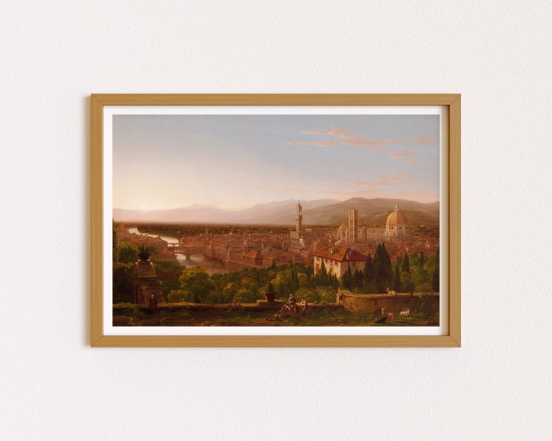 May include: A framed painting depicting a panoramic view of Florence, Italy. The painting shows the city from a distance, with the Arno River winding through the cityscape. The iconic Duomo, with its distinctive dome, is prominently featured in the background. The foreground features a group of figures enjoying the view from a hilltop.