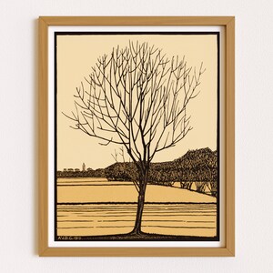 May include: A black and white line drawing of a bare tree in a field with a distant town in the background. The drawing is framed in a light brown wood frame. The text "A.D.C. 1919." is in the bottom left corner of the drawing.