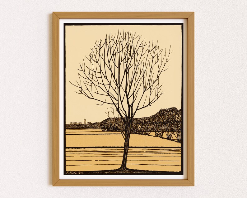 May include: A black and white line drawing of a bare tree in a field with a distant town in the background. The drawing is framed in a light brown wood frame. The text "A.D.C. 1919." is in the bottom left corner of the drawing.
