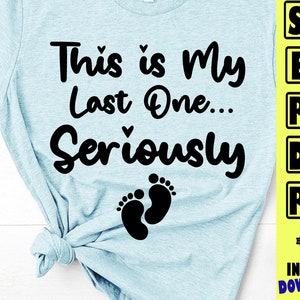 May include: A light blue t-shirt with black text that reads "This is My Last One... Seriously" with a pair of black baby footprints below the text.