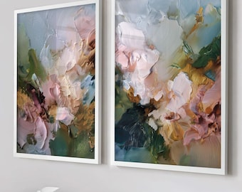 May include: Two framed abstract paintings with thick brushstrokes. The artwork features a palette of soft pinks, greens, blues, and gold. The paintings are in white frames, creating a modern and elegant aesthetic. The style is reminiscent of impressionistic floral art.