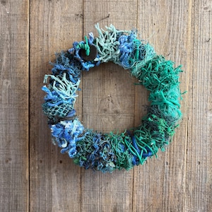 May include: A set of three ceramic mugs with a speckled, matte finish. The mugs are in shades of cream, light gray, and dark gray. Each mug has a simple, minimalist design and a rounded handle.