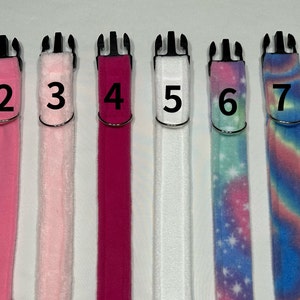 May include: Eight different dog collars in various colors and patterns. The collars are numbered 1 through 8. The collars are made of different materials, including fabric, fleece, and nylon.
