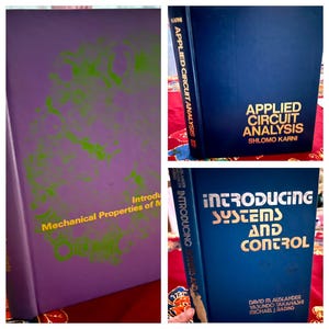 May include: Three hardcover textbooks: a purple book titled Mechanical Properties of Materials with green graphics, a dark blue book titled Applied Circuit Analysis by Shlomo Karni, and a dark blue book titled Introducing Systems and Control.