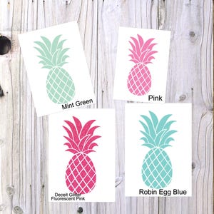 May include: Four pineapple designs in different colors: mint green, pink, robin egg blue, and fluorescent pink. The designs are on white backgrounds with the color names written below each design.