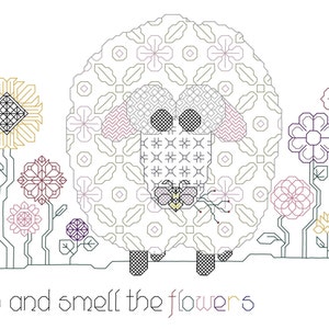 May include: A cross-stitch design featuring a sheep surrounded by stylized flowers in various colors. The sheep holds a small flower, and the text "Stop and smell the flowers" is at the bottom. The design is on a white background.