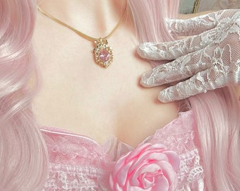 May include: A pink satin bodice with a large pink satin rose and pearl embellishments. The bodice is worn by a person with long pink hair and a gold necklace with a pink gem pendant.