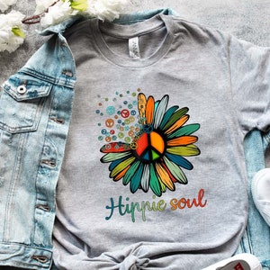 May include: A gray t-shirt with a colorful peace sign flower graphic and the text "Hippie soul".