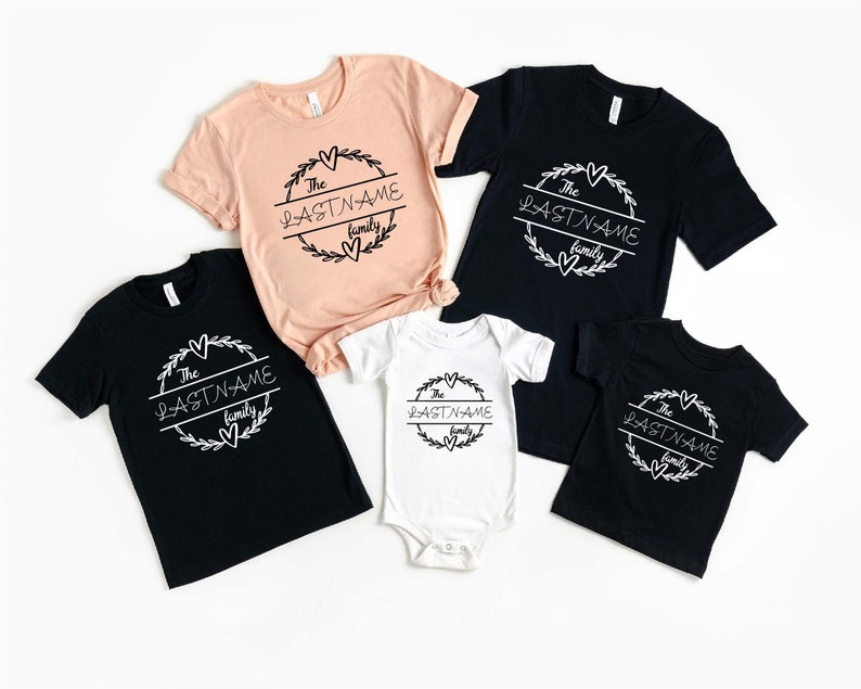 May include: Set of five black and peach t-shirts with a white graphic design. The graphic features a wreath with the text "The LASTNAME family".