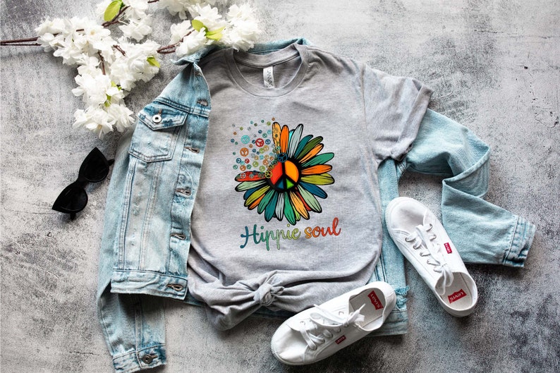 May include: A gray t-shirt with a colorful peace sign flower graphic and the text "Hippie soul".