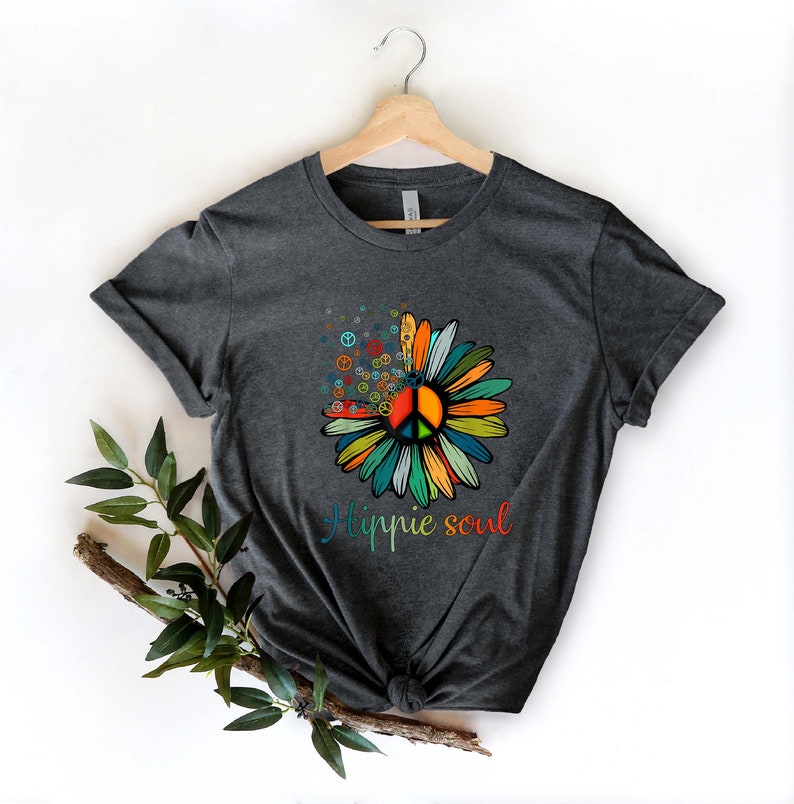 May include: A dark grey t-shirt with a colorful peace sign flower graphic and the text "Hippie soul" printed on the front.