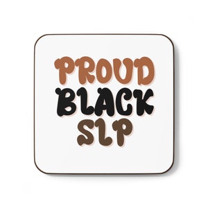 May include: A white coaster with the text "PROUD BLACK SLP" in brown and black lettering.