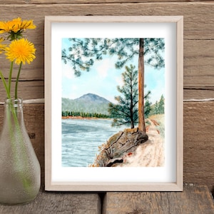 May include: Watercolor painting of a lake scene with a mountain in the background. A large pine tree stands on the right side of the image, with a smaller pine tree in the foreground. The lake is a light blue color, and the sky is a pale blue with white clouds.