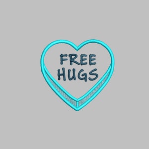 May include: A blue heart-shaped sweet with the text "FREE HUGS" in black.