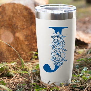 May include: White stainless steel tumbler with a blue floral design and the letter "J" in the center.