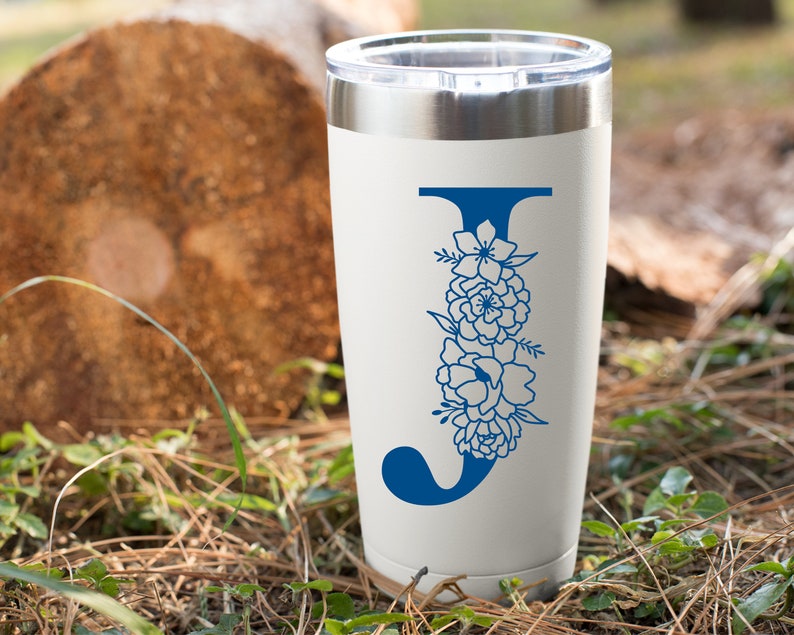 May include: White stainless steel tumbler with a blue floral design and the letter "J" in the center.