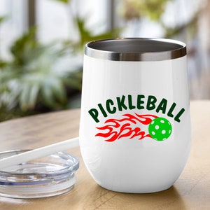 May include: White stainless steel tumbler with a red and green pickleball graphic and the text "Pickleball" in green letters.