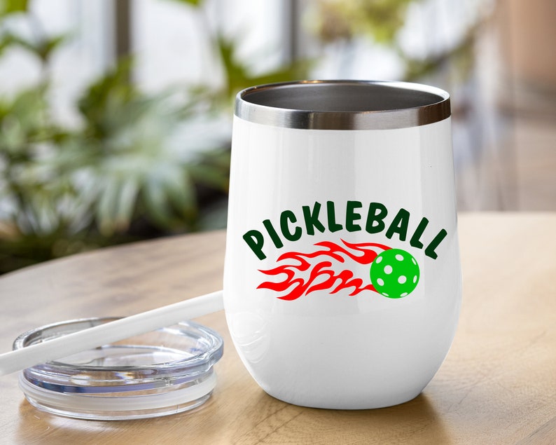 May include: White stainless steel tumbler with a red and green pickleball graphic and the text "Pickleball" in green letters.