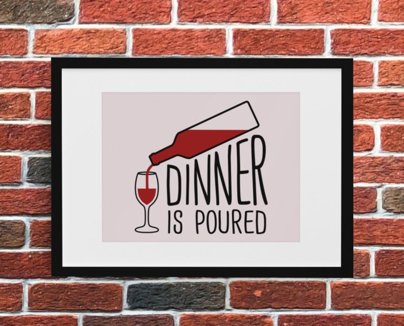 May include: A black framed print with a white background and a red wine bottle pouring into a wine glass. The text "Dinner is poured" is written in black below the image.