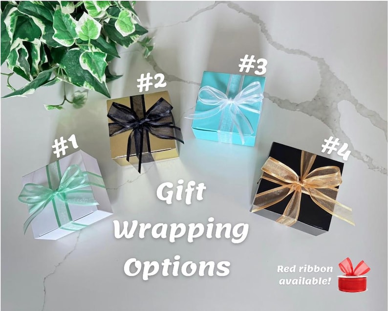 May include: Four gift boxes with different wrapping options are displayed. The boxes are white, gold, turquoise, and black, each adorned with a ribbon in various colors. Text on the image reads "Gift Wrapping Options."