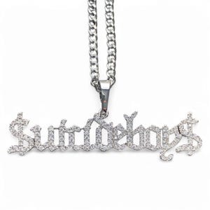 May include: Silver chain necklace with a pendant that says "Suicideboys" in a gothic font with clear rhinestones.