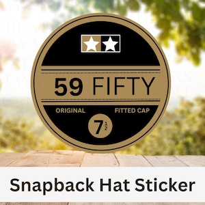 May include: A round sticker with a black and gold design. The sticker features the text "59 FIFTY" and "ORIGINAL FITTED CAP". It also includes the size "7 1/2" and two star icons. The words "Snapback Hat Sticker" are at the bottom.