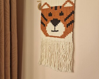 macrame knotted weave of a tiger. handmade from recycled cotton cord.