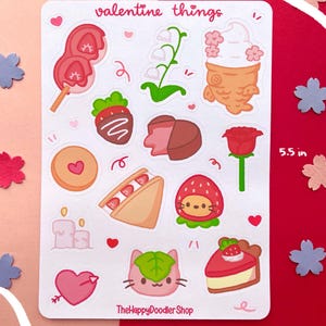 May include: A sheet of Valentine's Day themed stickers featuring a variety of cute illustrations, including hearts, strawberries, flowers, and desserts. The sheet measures 4 inches by 5.5 inches and includes the text "valentine things" and "TheHappyDoodlerShop".