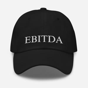 May include: A black baseball cap with the word "EBITDA" embroidered in white on the front.