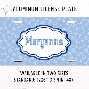 May include: A light blue aluminum license plate with a floral pattern and the name "Maryanne" in a decorative frame. The text "ALUMINUM LICENSE PLATE" is at the top. Available in two sizes: 12x6 inches or mini 4x7 inches.
