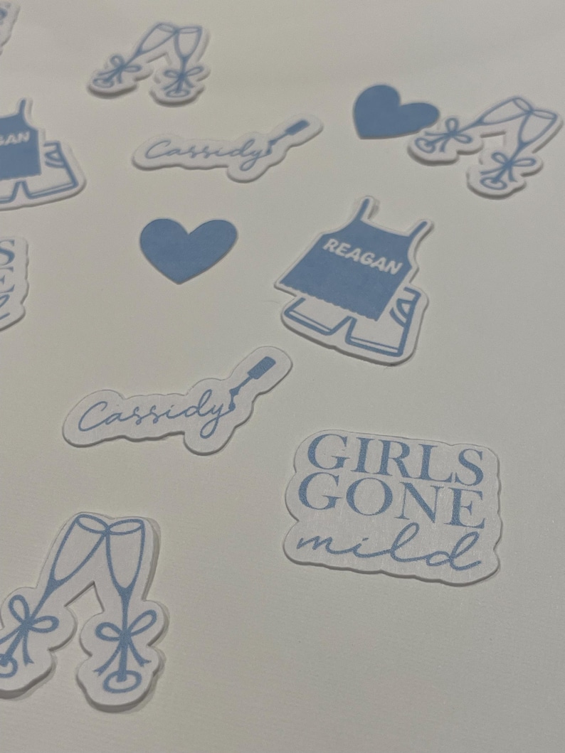 May include: A set of blue and white stickers with various designs, including hearts, champagne glasses, and text that says "Cassidy" and "Girls Gone Mild".